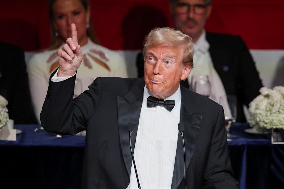 Former President Donald Trump pointing upward as he speaks at the 79th annual Alfred E. Smith Memorial Foundation Dinner in New York City.
